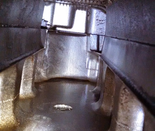 Inside the intake, oil puddle in the back