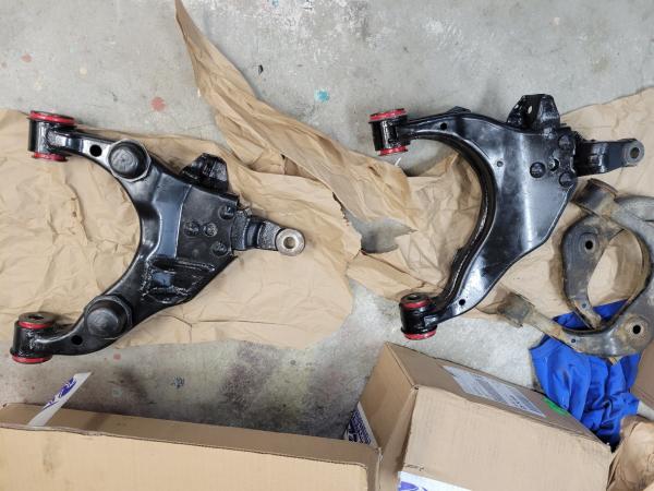 Lca's with the Energy Suspension poly bushings installed, with my old uca's right in the pic