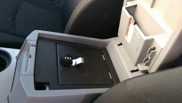 Locking gun safe in factory console.