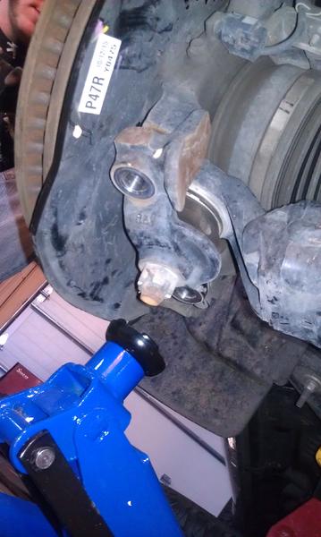 Lower ball joint detatched (floor jack beneath to prevent over-extention).