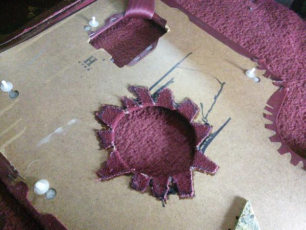 Marked the back side of the panel with the opening in the sheet metal, cut panel with serrated knife, glued carpet to backside of panel.