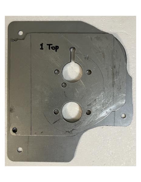 Mounting plate with four spacers stacked on top, ready to install.