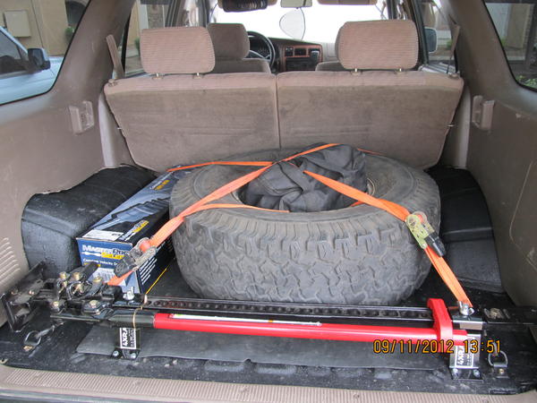 Moved the spare for extra gound clearance.  Smitty Bilt HO air compressor in the spare.  Extra CV axle with life time warranty.  High Lift Jack and mo