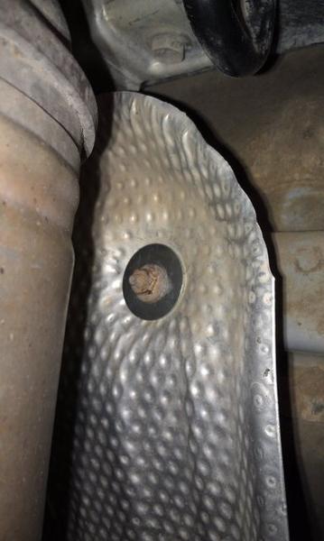Muffler heat shield fixed with fender washers.