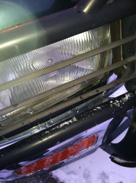 My broken headlight and pushed in brush guard