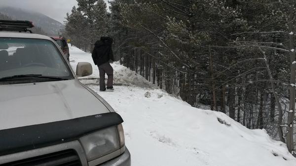 My buddy surveying the predicament we just got out of. We still got a half day of skiing and riding in after!