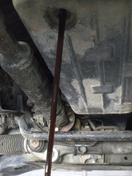 nasty (not red) old transmission fluid draining.