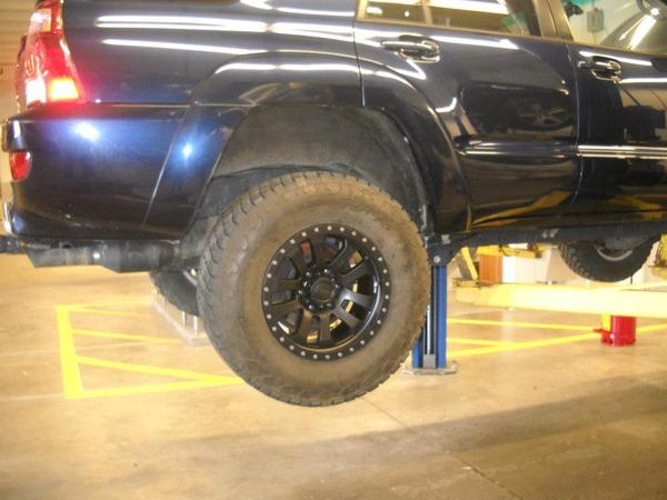On the lift at work installing the Pro Comp wheels with a set of 295/70R17 Nitto Terra Grappler tires.