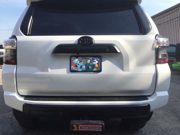 Painted rear Toyota badge, 4Runner badge, and bumper valance matte black. Added Blackhawks hitch cover bump step