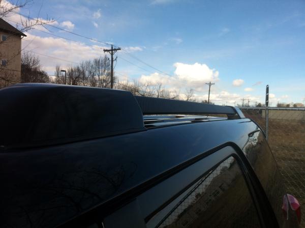 Painted the silver ends of the roof rack gloss black