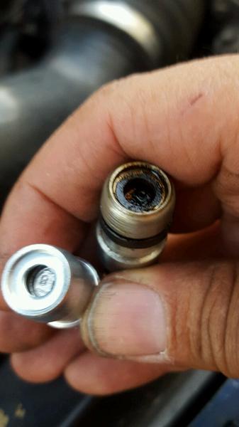 PCV valve replacement, old one has dry rubber ring which cracked off the old grommet... that ain't an o-ring i mistakenly thought it was for a sec! he