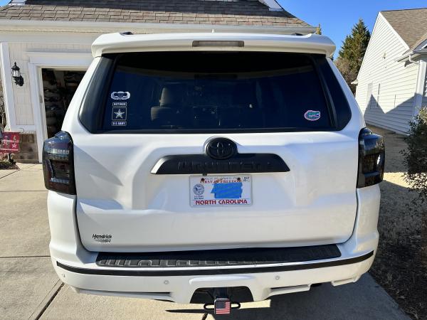 Plasti Dip of back chrome “4Runner” emblem with ABS Toyota symbol; Plasti Dip of chrome strip on bumper; black lens taillights with running sequence t