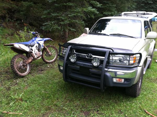 Playing in the mud with the YZ450 and my faithful runner