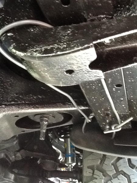 Pulling and securing the front mud flaps back to clear 265/70R17s