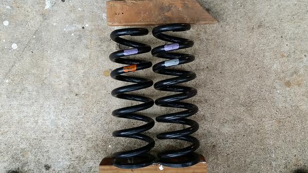 Purple/grey spring for DRIVER side
Orange/Grey Spring for PASSENGER side

Driver side spring has one more coil and uses a larger diameter wire for hig