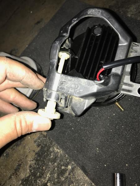 Pushing back and securing the alignment screw when attaching old mounting bracket to the Morimoto fog lights.