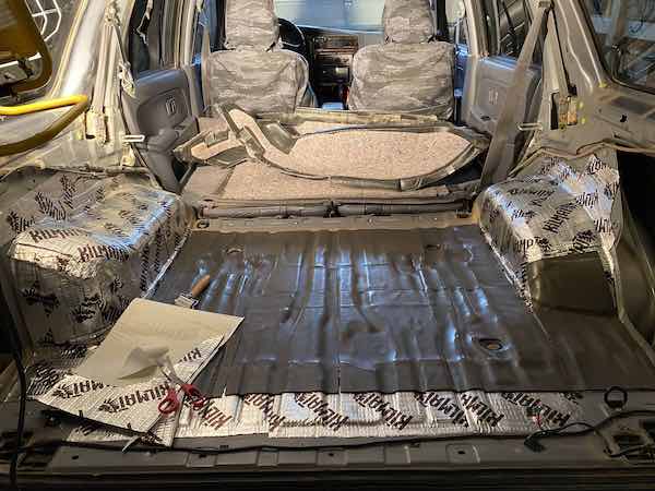 Putting the closed cell layer on top of the Kilmat in the back.