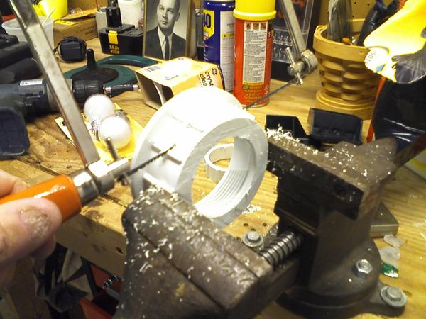 PVC "drainplate" fitting being cut to size