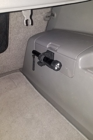 Quick Fist Clamp/ Amazon purchase
Small Maglite mount/industrial strength velcro.  Super strong and no need to make holes in the plastic panels.