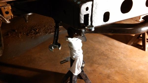 Re-attaching the receiver hitch via access holes.