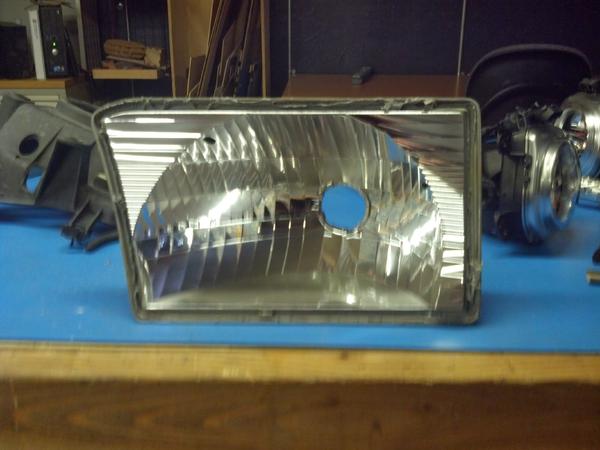 Reflector with glass and center piece removed

I used a heat gun on edge and a razor blade then a wide chisel to pry it open, Sort of a pain but Once 