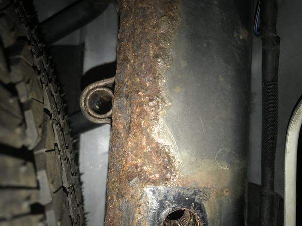 Scaling rust all over rear frame rail that runs past the spare tire. Same rail doubles as a hitch mount for receiver. The sub hitch bar cost $800.00 &