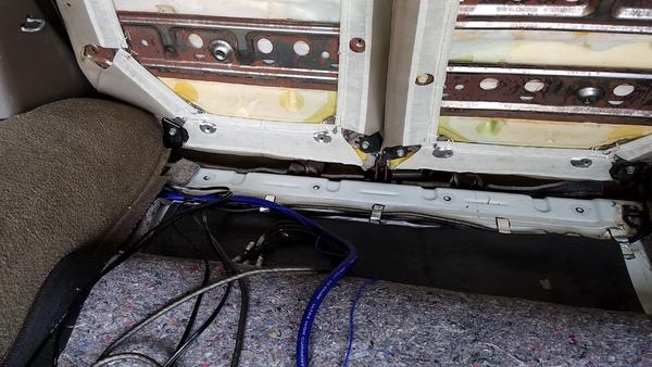 Slit in the carpet to come up the rear of the seat to show less wire.