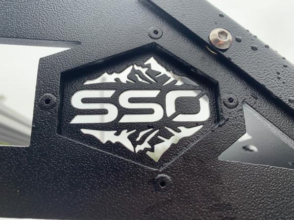 SSO changed from the stainless steel looking logo to powder coated black on their roof racks