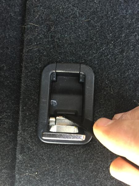 Step 1:  Lift rear most tie downs on both sides and pry up bolt cover.