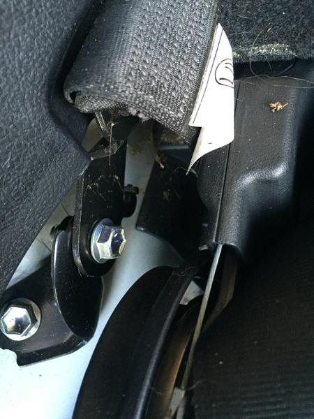 Step 6:  Identify the lower seat belt anchor bolt. This is the left side. The right side bolt is not on the side, it faces the back and may need an im