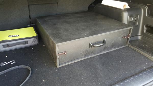 Storage drawer. Modular, allows for stacking and seats to be folded.