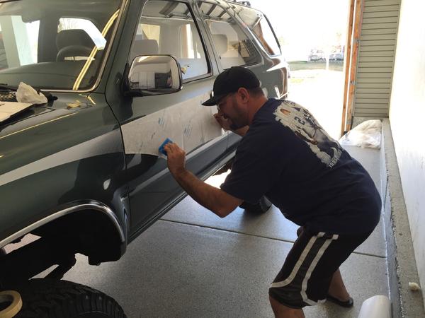 Stripe man installing the OEM replicas from James Dean creations in Tucson