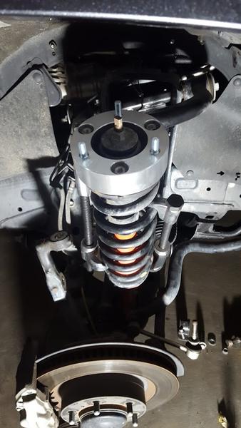 Strut - compressed the spring with the X-REAS lines attached and rotated top hat after installing the spacer. Bolts right up.