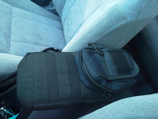 The center console's vinyl was cracked, so I opted to recover it with some cordura nylon. I used a 5.11 6X10 pack for the main cover. The molle webbin