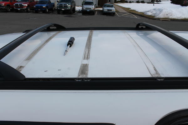 The crap underneath the crossbars, the white spots are what I removed with water and gentle pressure. It is almost all gone now, aside from heavy outl