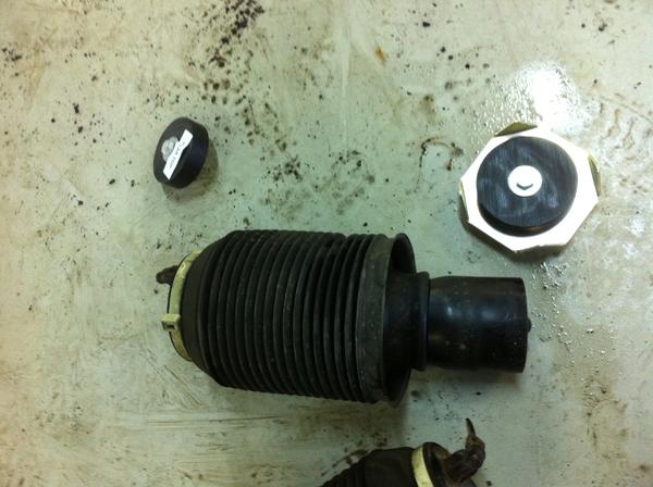 The metal plate in the top right is what now holds the base/bottom of the rear springs from the lift kit I had installed.