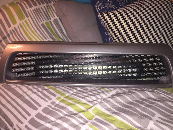 The original game plan: mounting the light bar behind the grille mesh.  Unfortunately, there's not enough room. . .