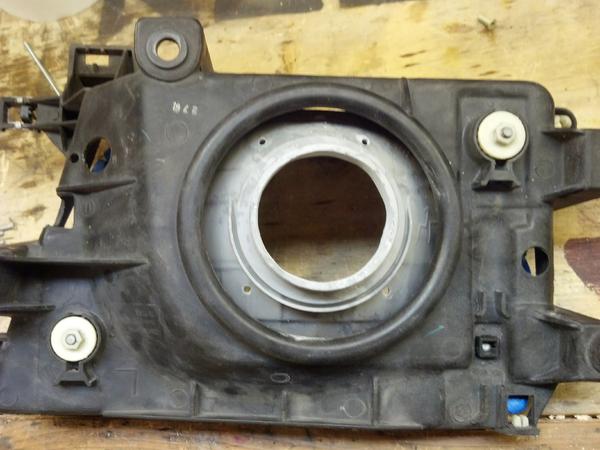 The two white plastic pieces adjust the angle of the headlamps. In my opinion you should align you projector coaxially with the bore of the thing stic