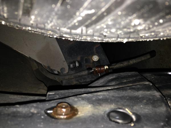 This is front pass side wheel well showing re-routed A/C drain line directing water drainage away from top of frame to the area pictured so drain wate