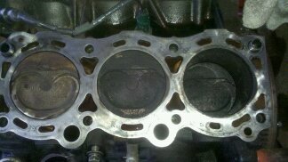 this is the driver side head sure looks to me like the head gasket was blown as clean as that one piston is but toyota "said" it wasnt