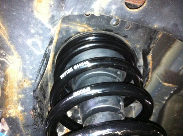 This shows the stock bumpstop installed to hold the top of the spring in place on the rear suspension.