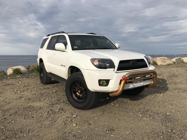 Two months later after purchase. Black, bronze theme with red highlights slowly being applied: black headlights, front grill plastidipped, yellow fogs