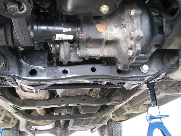 Underside including tranny cross member, with 2 small holes...