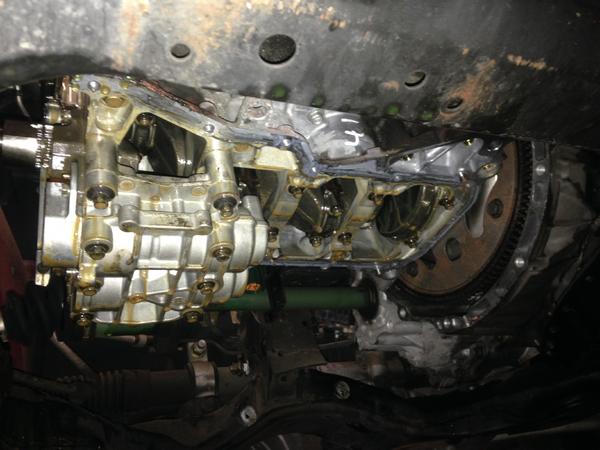 Underside of a Sentra with oil pan off (to remove timing cover (to remove head (to repair leak)))