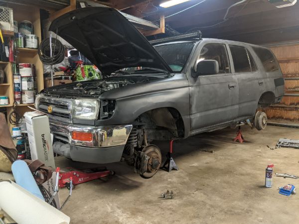 Up on jack stands to drop the tank.