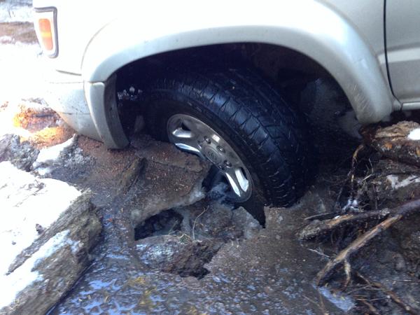 View of the front wheel and why I was locked into place. That ice was so thick that I had to drop big rocks on it to break it up so I could move.