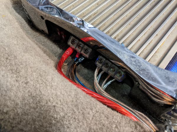 Wiring for amp. Runs into the cutout in the carpet for the driver's side seatbelt sensor.